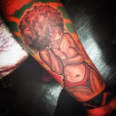 a woman with an afro haircut on her arm is shown in this tattoo design