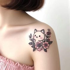 a woman's shoulder with a cat and flowers tattoo on her left side arm