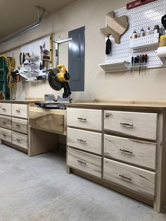 the workbench has many drawers and tools on it