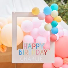 a happy birthday card with balloons in the shape of a frame and a sign that says happy birthday charlie