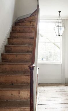 a wooden staircase leading up to a window