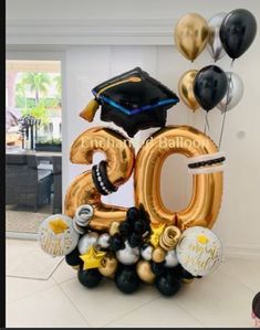 the balloon number twenty five is decorated with black, gold and white balloons