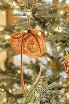 an ornament hanging from the top of a christmas tree decorated with orange slices