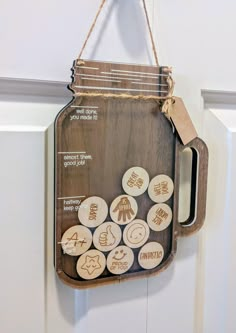 a wooden sign hanging from the side of a door with buttons attached to it's handle