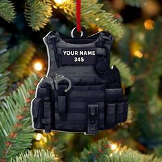 an ornament hanging from a christmas tree with a name on the back of it