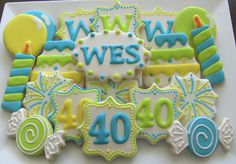 decorated cookies on a plate with the words ww west written in blue, green and yellow