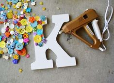 the craft supplies are laying out on the floor next to the sewing machine and scissors