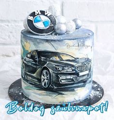 a birthday cake with a bmw car on it's side and some balls in the middle