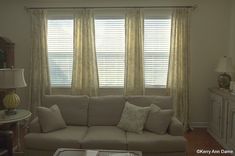 a living room filled with furniture and windows