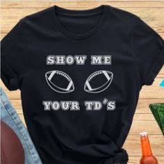 T-Shirt Colors Available : - Black - Navy Blue Sizes Available: - S - M - L - Xl Get Ready To Score Some Laughs With Our Exclusive Funny Football T-Shirt. The Shirt Features A Bold And Humorous Design That Reads "Show Me Your Td's" - A Play On The Phrase "Show Me Your T's" (Meaning "Show Me Your Toughness"). Whether You're A Fan Of The Nfl, College Football, Or Just Love The Game, This Shirt Is The Perfect Way To Show Off Your Sense Of Humor On Game Day. Made With High-Quality Materials And Craf Cricut Football Shirts Kids, Trendy Black Tops For Game Day, Short Sleeve Tops With Funny Text For Game Day, Game Day Graphic Tee With Funny Print, Team Spirit Slogan Short Sleeve Tops, Funny Print Crew Neck Top For Game Day, Crew Neck Tops With Funny Print For Game Day, Black Shirt With Text Print For Game Day, Black Text Print Shirt For Game Day