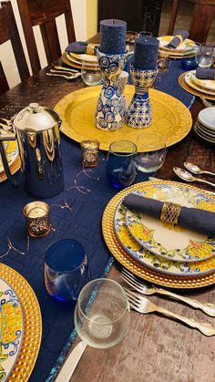 the table is set with blue and yellow dishes