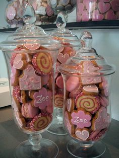 two glass jars filled with pink and white candies