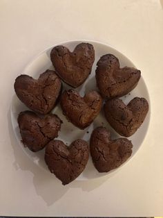 heart shaped cookies are on a white plate