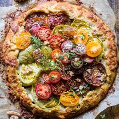 a pizza topped with tomatoes, cucumbers and other toppings