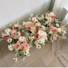 a bouquet of flowers sitting on top of a wooden floor