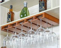 several wine glasses are lined up on a shelf