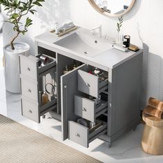 a bathroom vanity with drawers and a mirror on the wall next to a potted plant