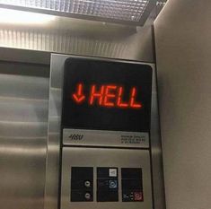 a sign that says hell on the front of an escalator in a subway