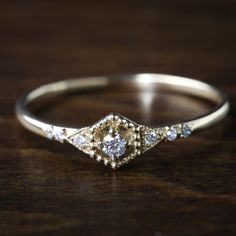 a diamond ring sitting on top of a wooden table