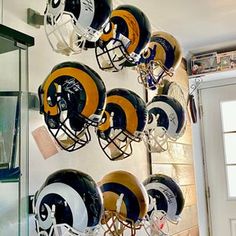 a bunch of helmets are hanging on the wall