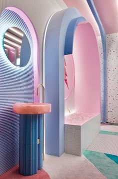 a bathroom with pink, blue and white walls is pictured in this image from the inside