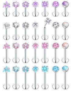 an assortment of piercings with different colors and designs on them, all in various sizes