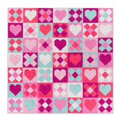 a pink and blue patchwork quilt with hearts on the front, in different colors