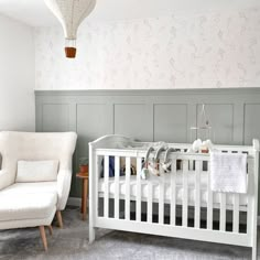 a baby's room with a white crib and rocking chair