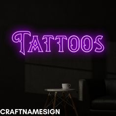 a purple neon sign that says tattoo's on the wall next to a chair