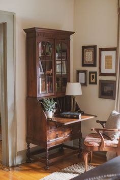 a room with a chair, desk and bookshelf