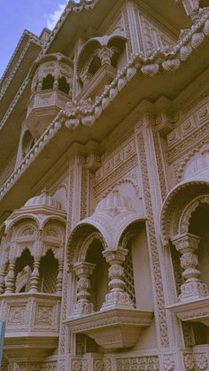 an intricately carved building is shown against the blue sky