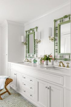 a bathroom with two sinks, mirrors and a stool in it's center area