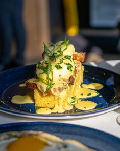 a blue plate topped with food on top of a table