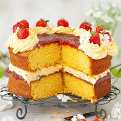 a cake that has been cut into pieces and is sitting on a wire rack with flowers around it