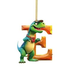 a cartoon dinosaur hanging from the letter e