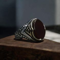 This elegant and unique ring is crafted from 925 sterling silver, featuring a bronze top piece. The oval-cut onyx garnet stone is beautifully set, standing out with its vintage-inspired design. The weight may vary depending on the size, with an average weight of 12.9 grams. It's the perfect choice for gifting to loved ones on special occasions! 🎁💍 Features: 925 sterling silver Bronze top piece Oval onyx garnet stone Weight: 12.9 grams (may vary by size) #gift #giftsformen #vintagering #925silv Garnet Stone Ring For Men, Stone Ring For Men, Stone Rings For Men, Garnet Stone Ring, Sterling Silver Mens Rings, Mens Silver Rings, Garnet Stone, Ring Oval, Men's Ring