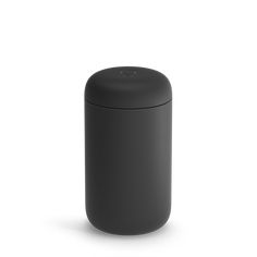 a black trash can sitting on top of a white floor