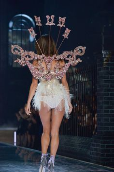 a model walks down the runway in a costume