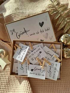 a box filled with lots of cards and clothes pins