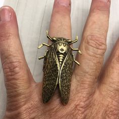 "Cicada statement ring in brass with an adjustable ring band. Extra large ring! Cicada charm measures 2\" long and it has been securely attached to a solid brass adjustable ring band. High quality and measures 1/2\" wide. Will fit most all ring sizes comfortably. Also available in silver: https://www.etsy.com/listing/776348545/silver-cicada-ring-extra-large-statement?ref=shop_home_active_1&frs=1 All items ship free I offer quick shipping and all packages arrive thoughtfully wrapped. I also o Bug Wedding Ring, Cicada Ring, Bug Rings, Cicada Jewelry, Crystal Necklace Diy, Insect Jewelry Gold, Bug Ring, Insect Ring, Handwritten Gifts