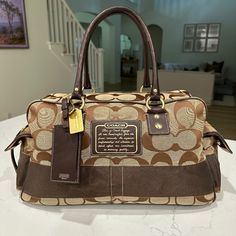 Excellent Condition. Approximately 20”X8”X10” Designer Brown Duffle Bag With Large Capacity, Designer Brown Luggage For Daily Use, Designer Brown Tote Duffle Bag, Rectangular Brown Luggage For Shopping, Designer Brown Rectangular Duffle Bag, Designer Brown Duffle Bag With Top Carry Handle, Designer Brown Luggage, Brown Rectangular Duffle Bag For Shopping, Brown Duffle Bag With Double Handle For Shopping