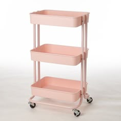 a pink cart with two trays on it