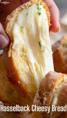 a hand holding a piece of bread with cheese on it and the words hasselback cheesy bread