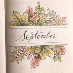 an open notebook with leaves and the word september written on it in black ink,