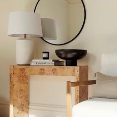 a mirror, lamp and chair in a room