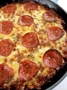 a pepperoni pizza sitting on top of a pan