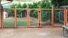 a fenced in backyard area with a chicken on the ground