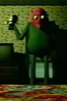 a cartoon character is sitting in front of a television