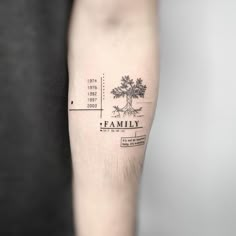 a family tree tattoo on the left forearm and arm, with an inscription below it