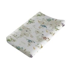 an image of a baby changing pad with dinosaurs on it's back and sides